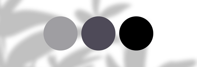 Three minimalist color swatches in grey, charcoal, and black on a white background
