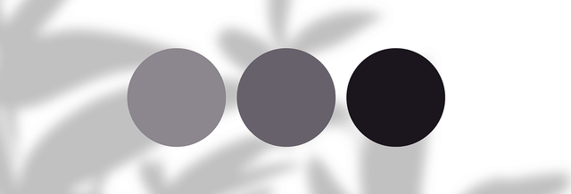 Three gray and black color swatches on a white background with blurred shadows