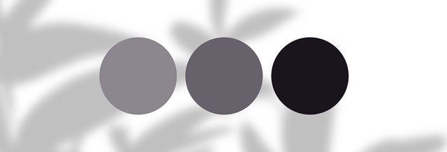 Three grey and black color swatches on a blurred abstract background, fashion palette