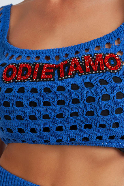 Blue crochet crop top with red embellished ODIE TAMO lettering, fashion detail closeup