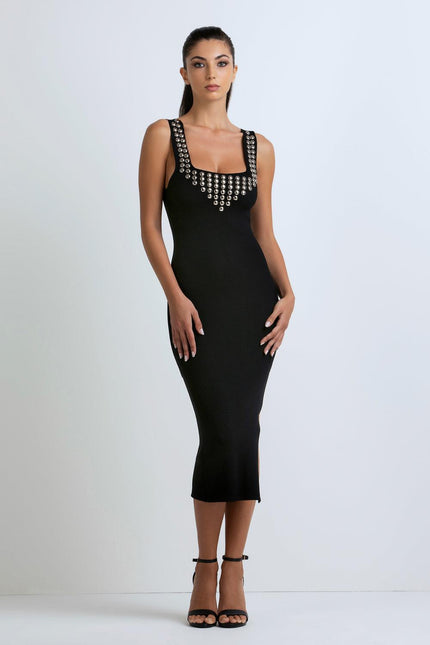 Woman wearing black sleeveless midi dress with metallic stud details, fashion dress