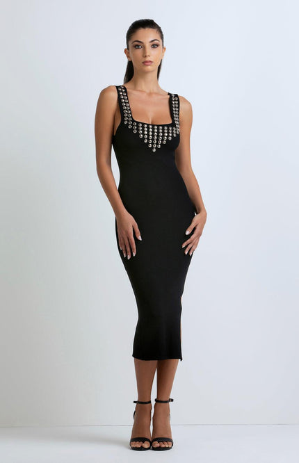 Woman wearing black sleeveless midi dress with metallic stud details, fashion dress