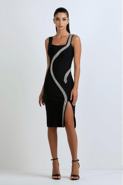 Woman in a black midi dress with silver sequin detailing and thigh-high slit