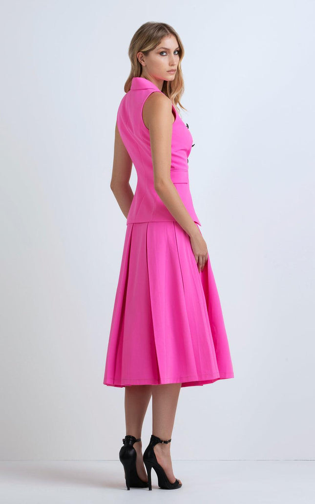 Woman in sleeveless hot pink midi dress with flared skirt and black high heels