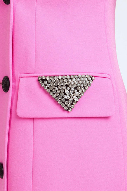 Detail of pink blazer pocket with crystal triangle brooch and decorative buttons
