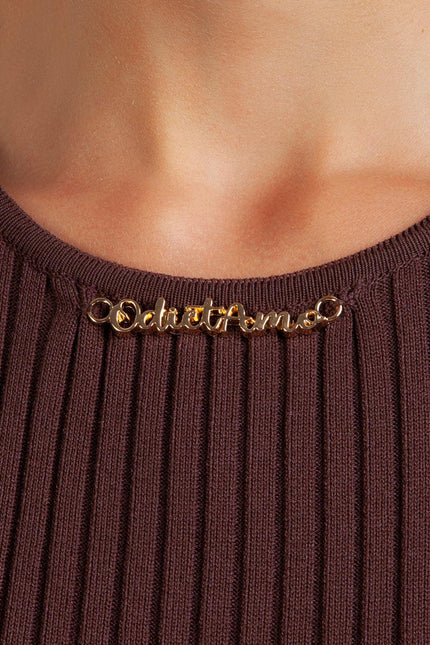 Close-up of gold Odi et Amo detail on ribbed brown knit top neckline