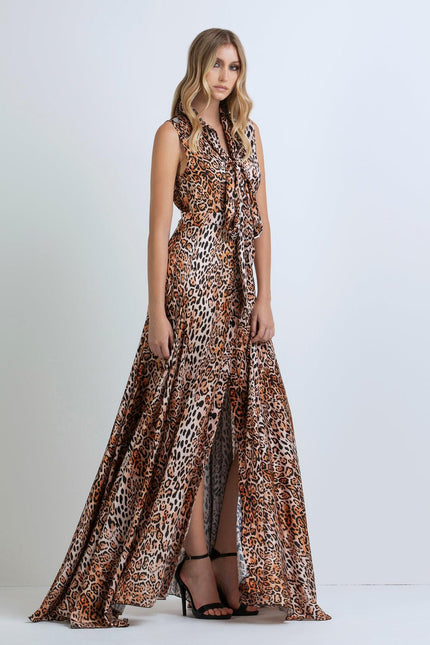 Woman wearing sleeveless leopard print maxi dress with front slit and black heels