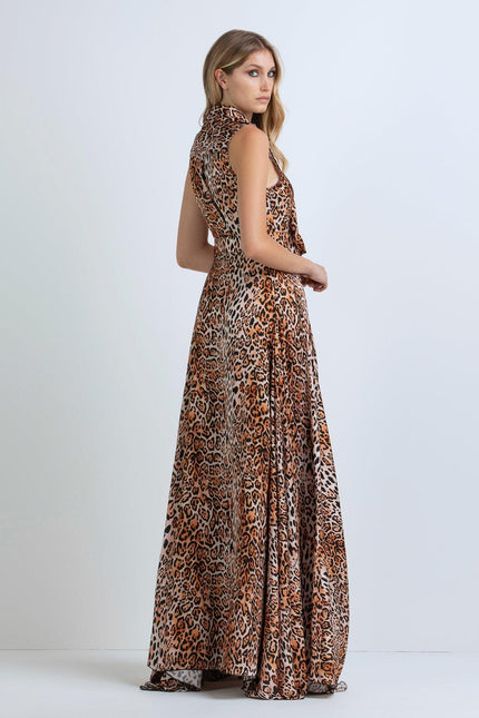 Woman wearing a sleeveless leopard print maxi dress, side view