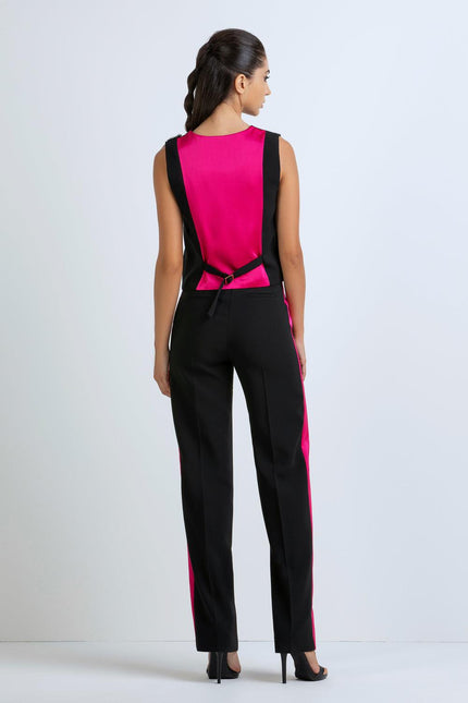 Woman wearing a black and fuchsia sleeveless jumpsuit with back buckle detail