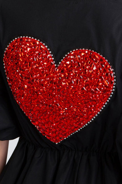 Black dress with large red crystal heart embellishment and rhinestone details