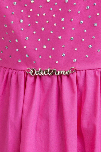 Fuchsia pink dress with rhinestone details and metallic script accent on waist