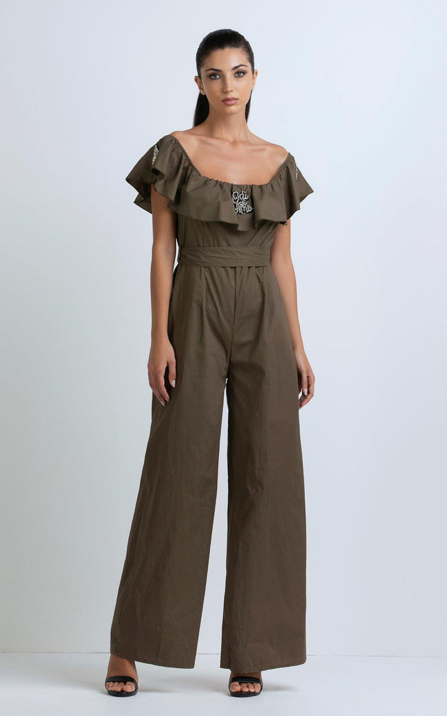 Woman wearing an olive green off-shoulder jumpsuit with ruffle detail and wide-leg pants