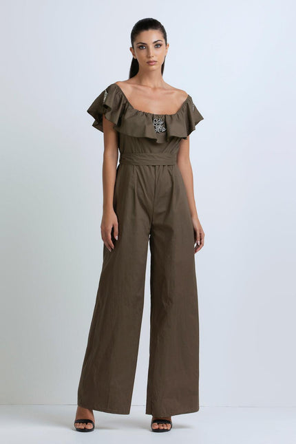 Woman wearing an olive green off-shoulder jumpsuit with ruffle detail and wide-leg pants