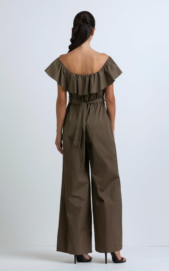 Woman wearing off-shoulder olive jumpsuit with ruffle neckline and wide-leg pants