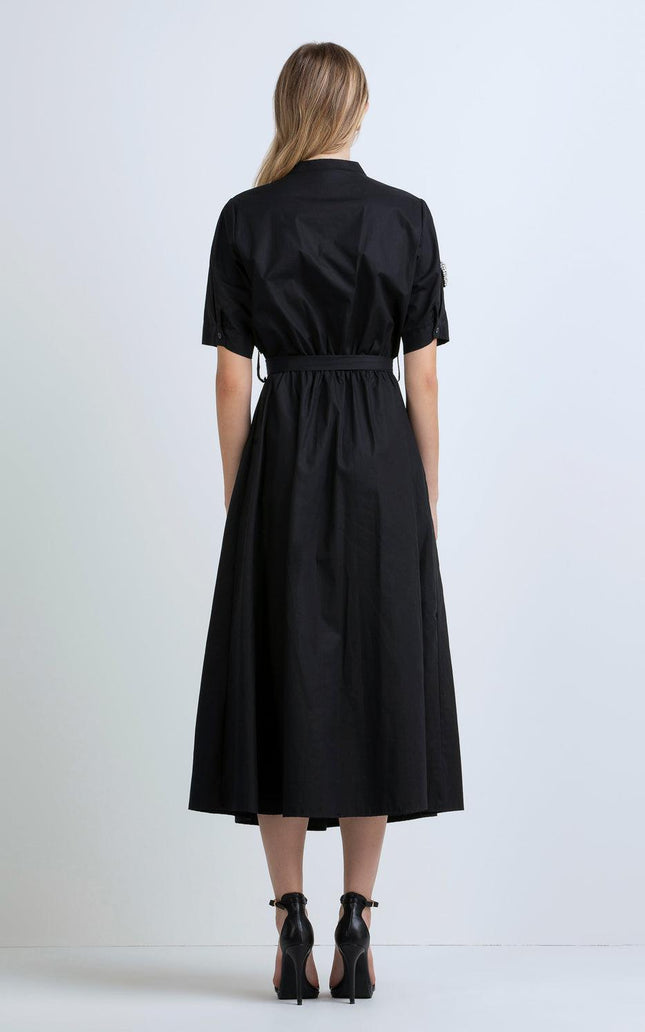 Woman in black midi shirt dress with short sleeves and belted waist, back view