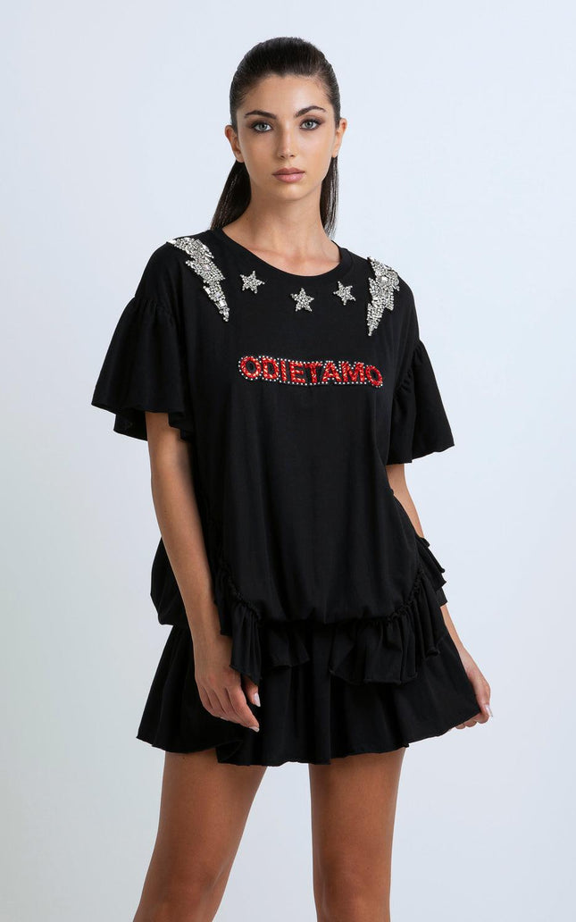 Woman wearing black embellished dress with ruffle sleeves and star details