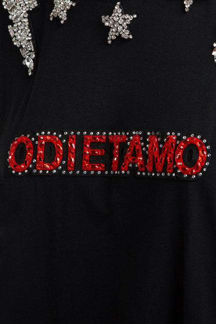 Black fabric with red embellished ODIETAMO text and sparkling rhinestone star details