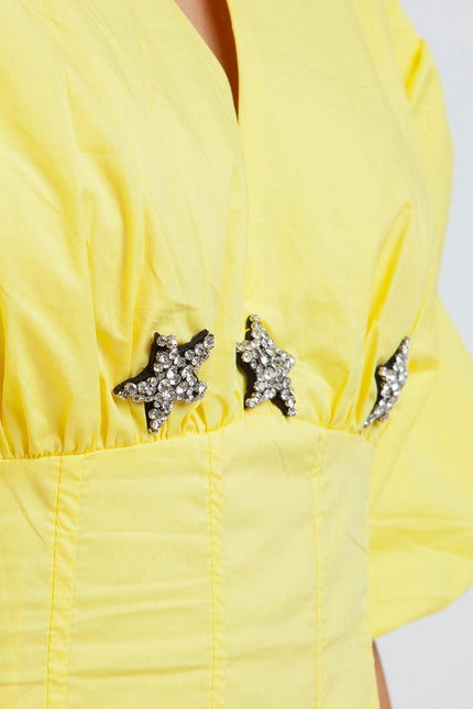 Yellow dress with star-shaped rhinestone embellishments on the bodice