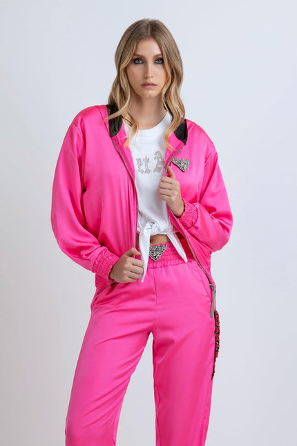 Woman in hot pink tracksuit with rhinestone details and white tied t-shirt, fashion look