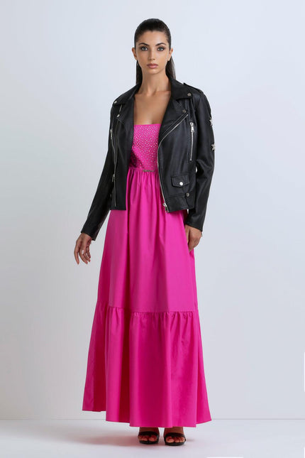 Woman in a black leather jacket and vibrant pink maxi dress, fashion studio shot