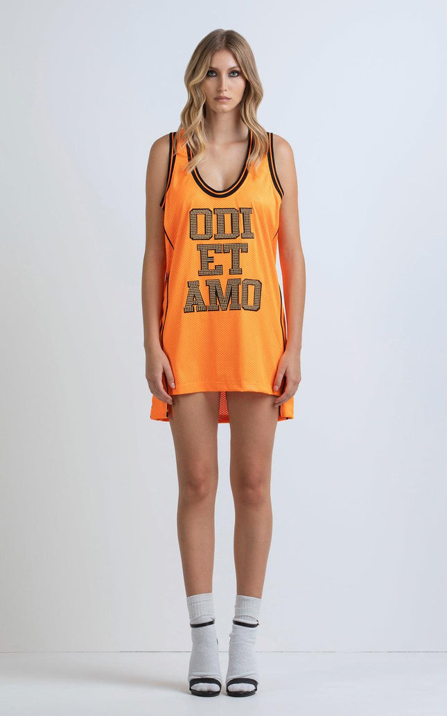 Woman wearing orange sleeveless mesh dress with bold lettering, sporty fashion style
