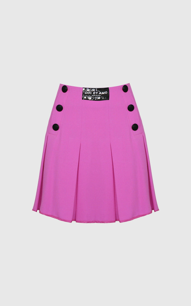 Pink pleated mini skirt with black buttons and decorative patch on front