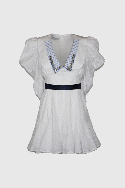 White eyelet mini dress with puff sleeves, embellished collar, and striped V-neck detail
