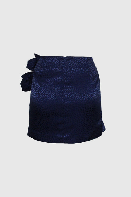 Women's navy blue mini skirt with subtle animal print and side bow detail