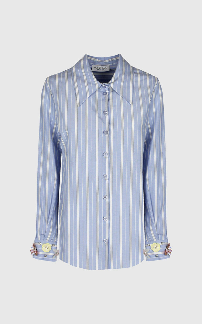 Light blue striped women's shirt with long sleeves and floral cuffs, front view