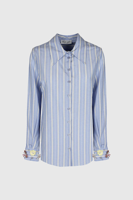 Light blue striped women's shirt with long sleeves and floral cuffs, front view