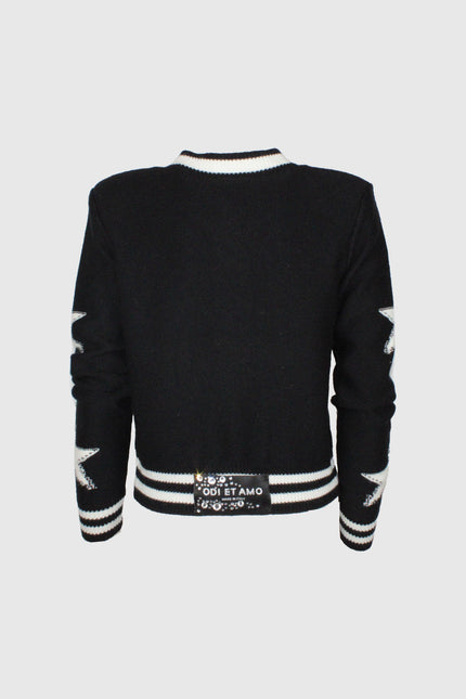 Black retro knit jacket with white star patches on sleeves, striped trim, and embellished back label