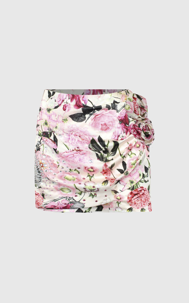 Mini skirt with pink floral print, ruched details and side flower accent on white background