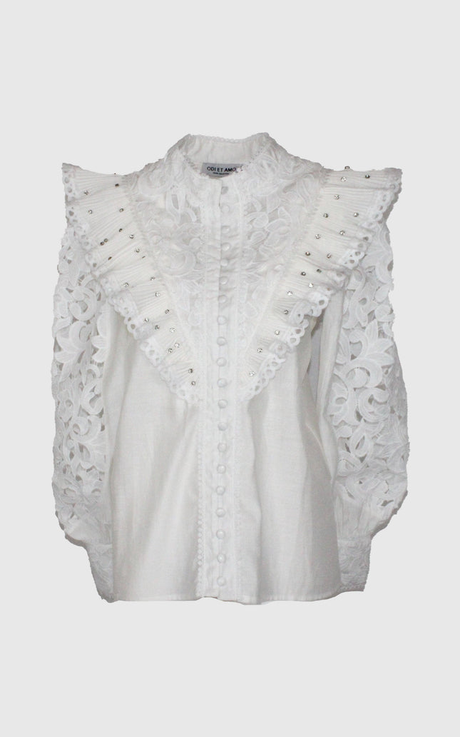 White lace blouse with ruffled studded shoulders and floral embroidered sleeves