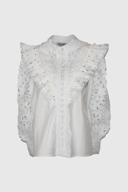 White lace blouse with ruffled studded shoulders and floral embroidered sleeves