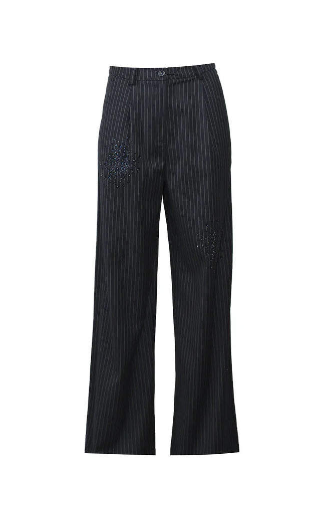 Black pinstripe wide-leg trousers with decorative studs and mid-rise waist