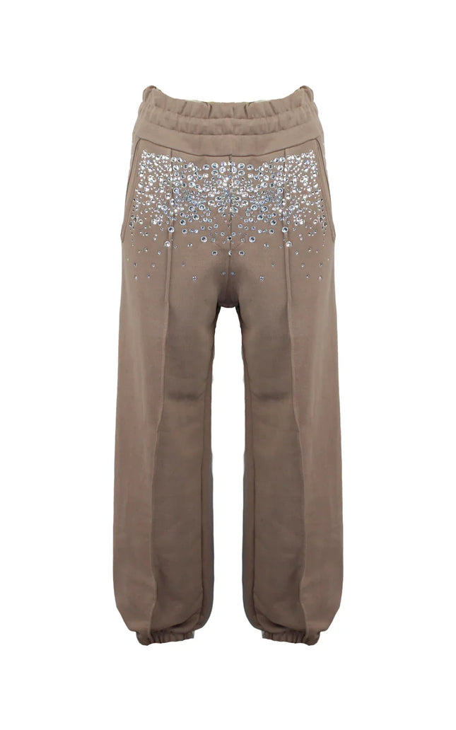 Beige jogger pants with sparkling rhinestone embellishments on the front