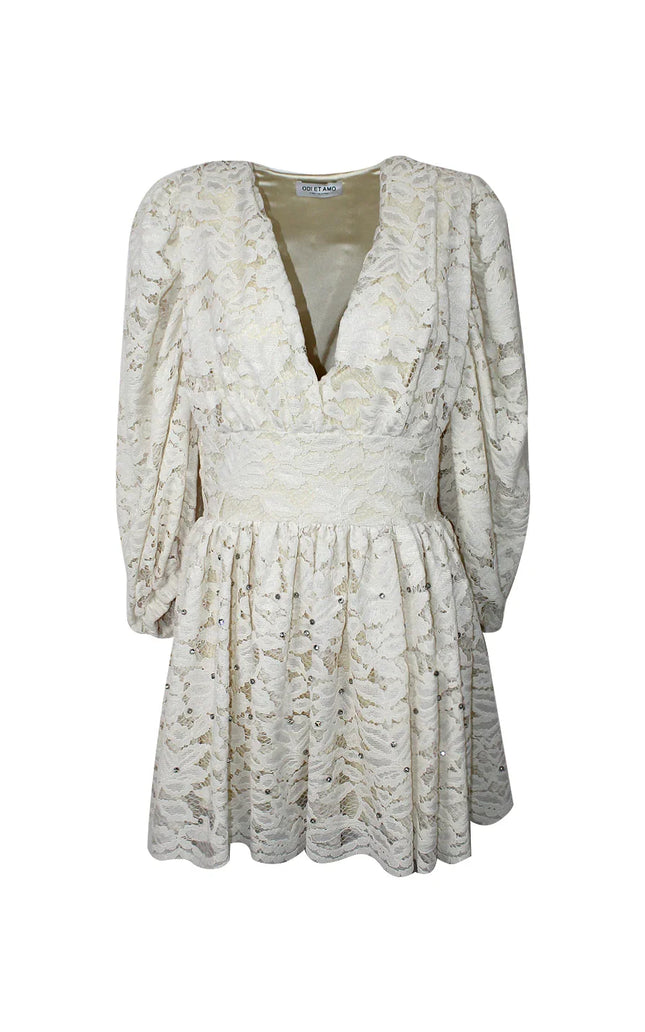White lace mini dress with long sleeves, deep V-neck, and sequin embellishments