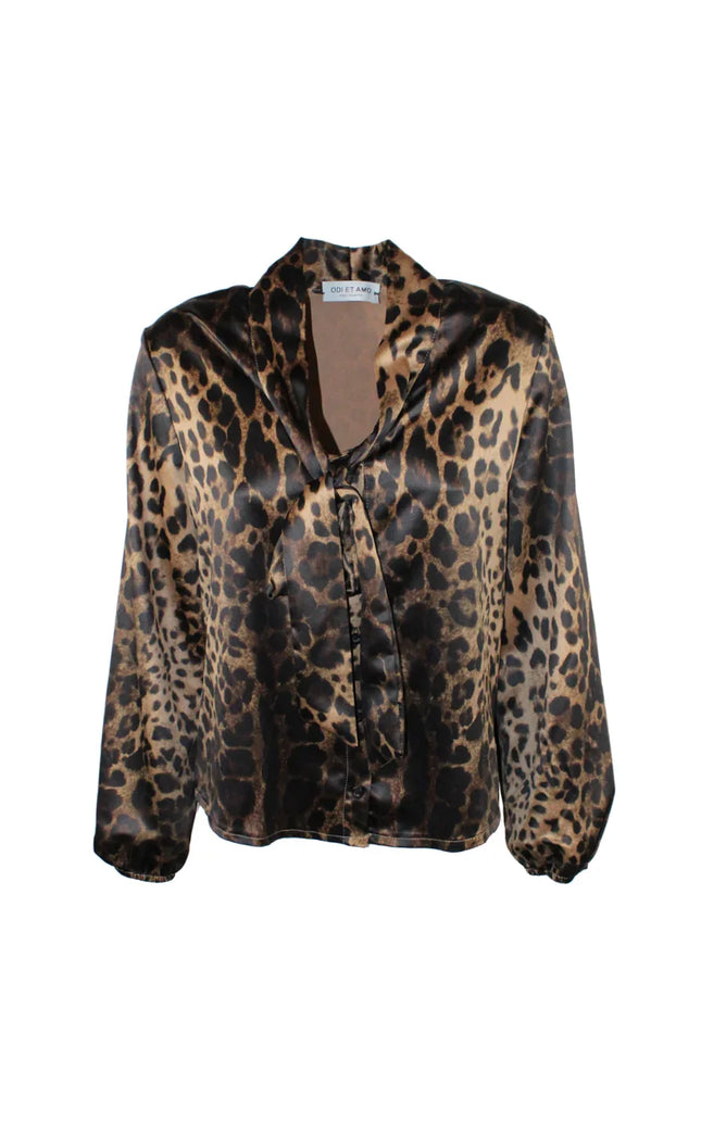 Women's satin blouse with leopard print and tie neck, long sleeves, on white background.