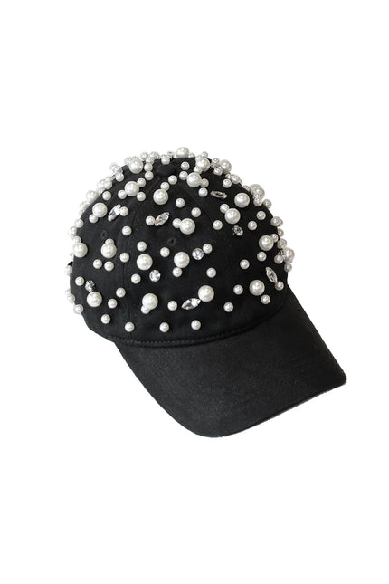 Black baseball cap decorated with pearls and rhinestones on white background