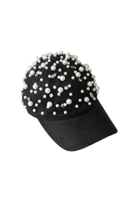 Black baseball cap decorated with pearls and rhinestones on white background