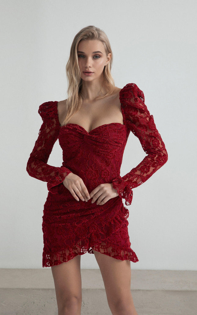 Woman wearing a fitted red lace mini dress with puffed long sleeves