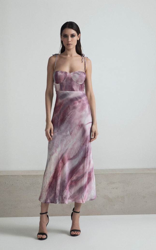Woman wearing a pink and purple marble pattern satin dress with spaghetti straps