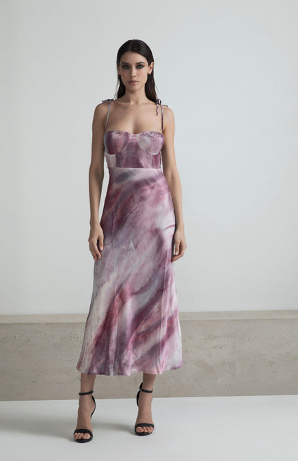 Woman wearing a pink and purple marble pattern satin dress with spaghetti straps