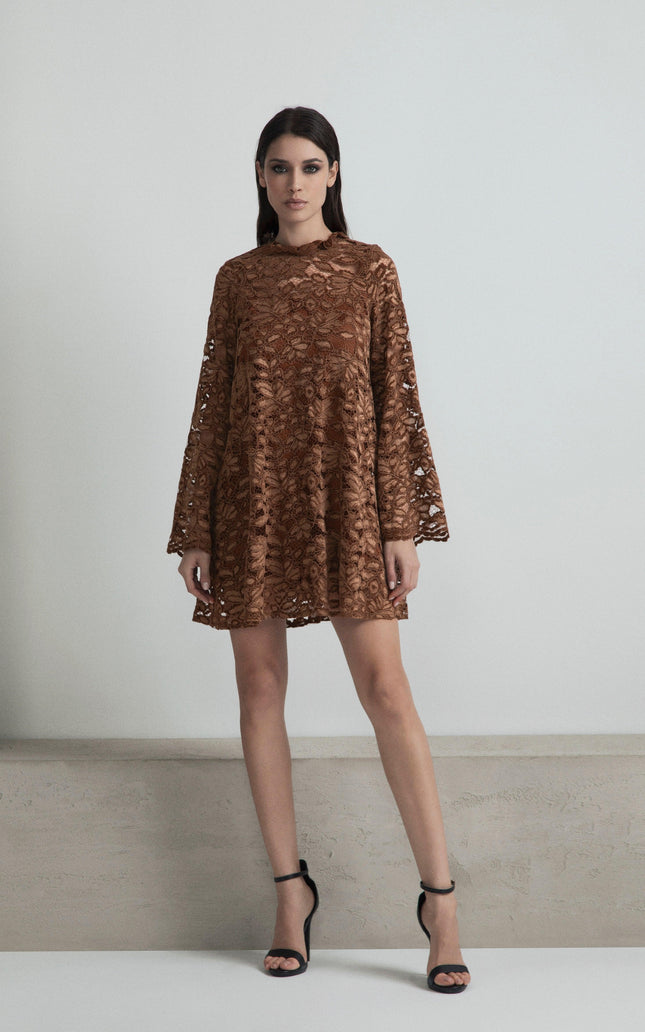 Woman wearing a brown lace mini dress with bell sleeves and black heels, fashion photoshoot