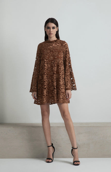 Woman wearing a brown lace mini dress with bell sleeves and black heels, fashion photoshoot