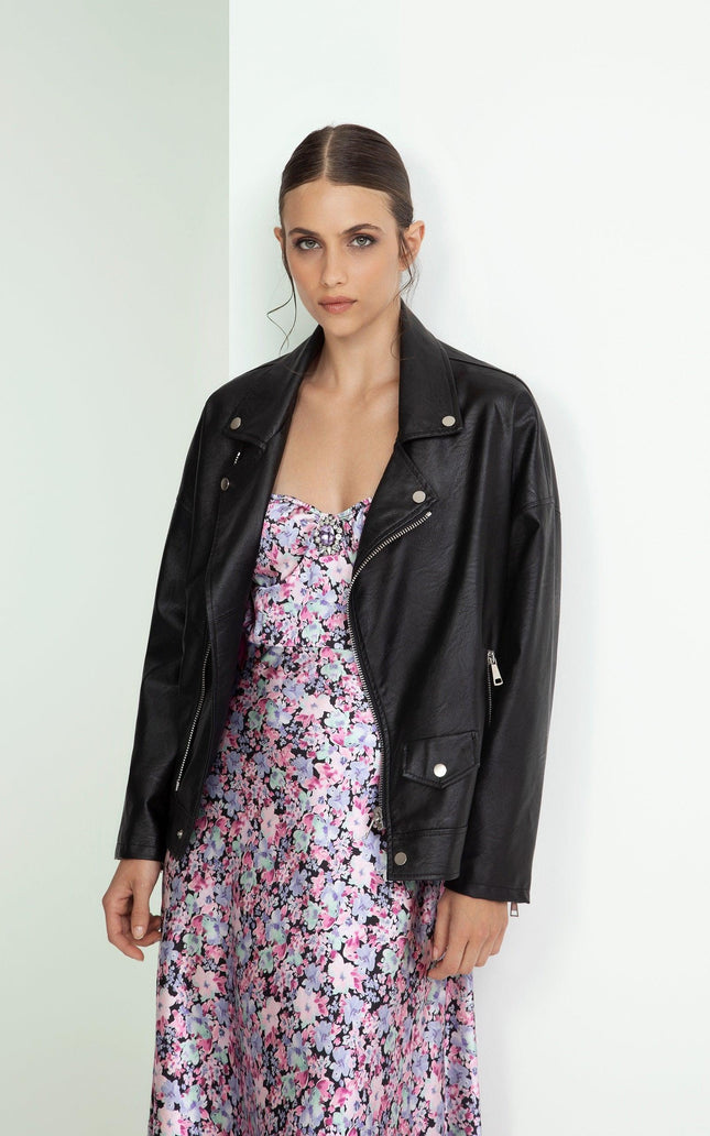 Woman in black leather jacket over a pink floral dress, modern and elegant fashion style