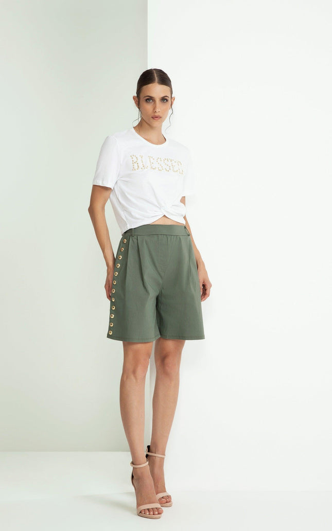 Woman in white 'Blessed' t-shirt and green high-waisted shorts with side buttons