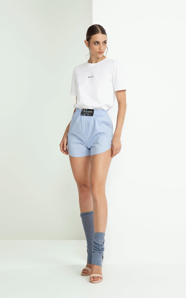 Woman in white t-shirt and light blue shorts with sporty chic style, fashion outfit