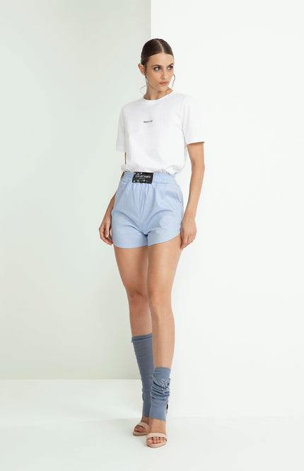 Woman in white t-shirt and light blue shorts with sporty chic style, fashion outfit