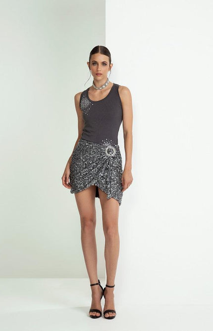 Woman in a sleeveless black top and sequin mini skirt with high heels, fashion photoshoot